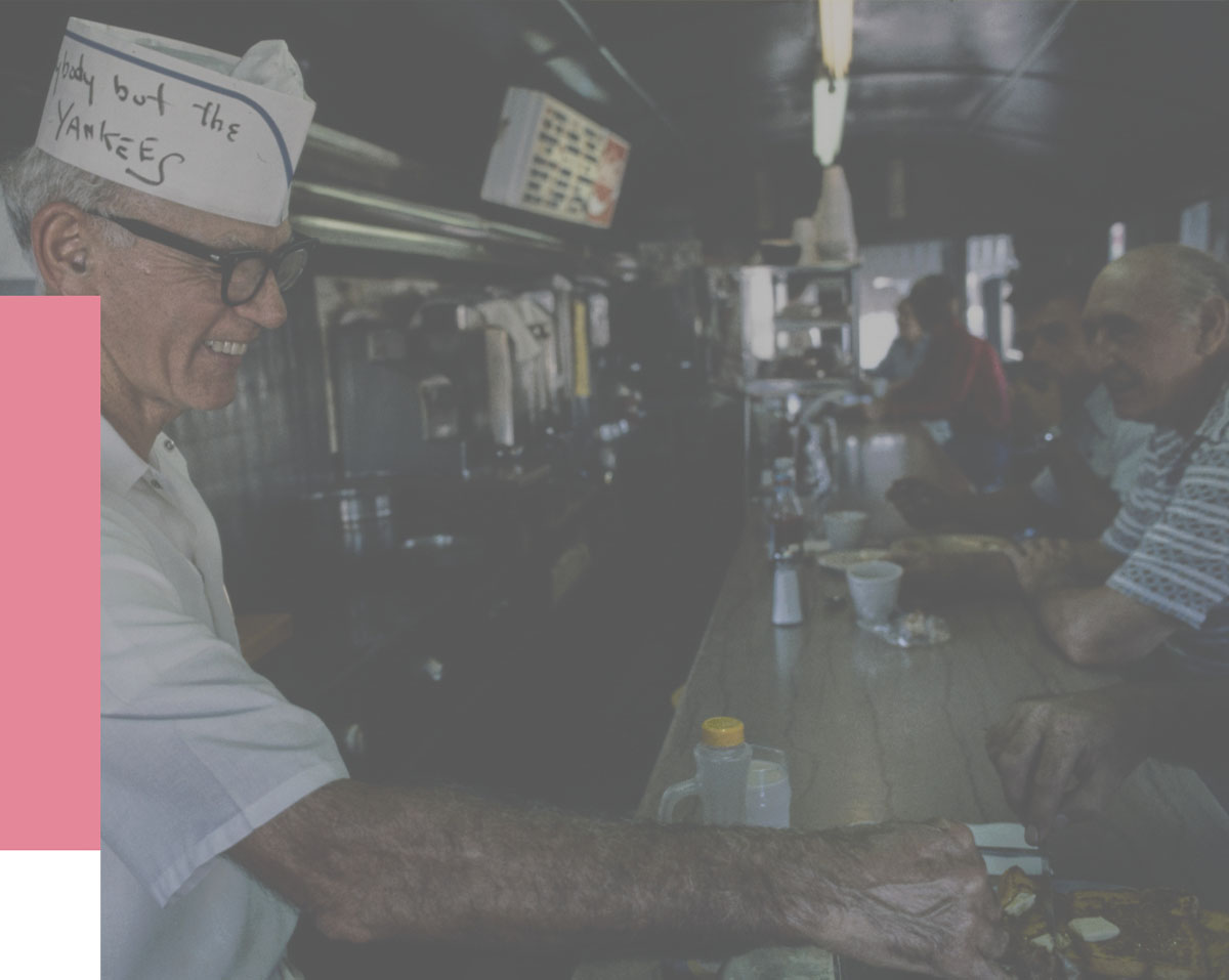 An old man serving cafe in a brunch spot.