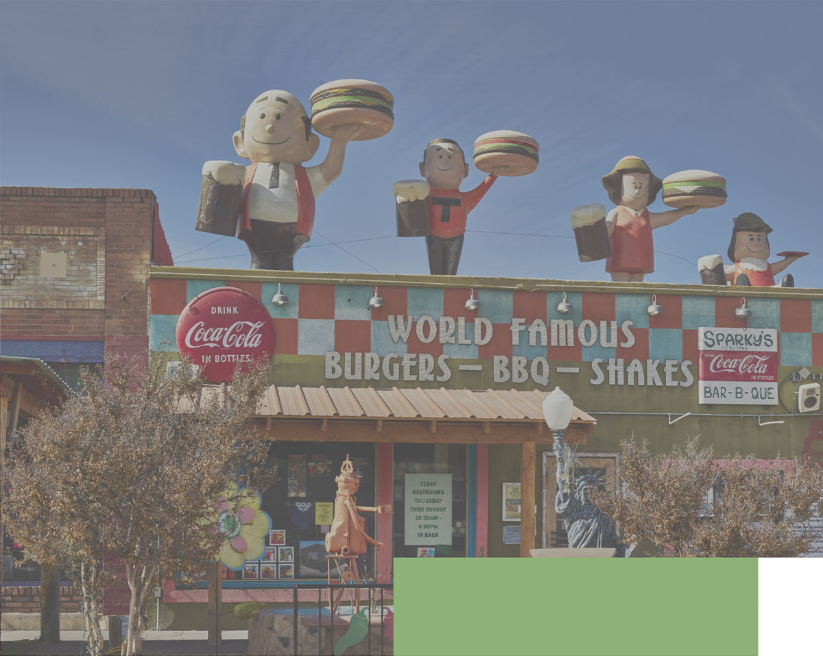 Photo of a restaurant with a sign reading 'World famous Burgers - BBQ - Shakes'