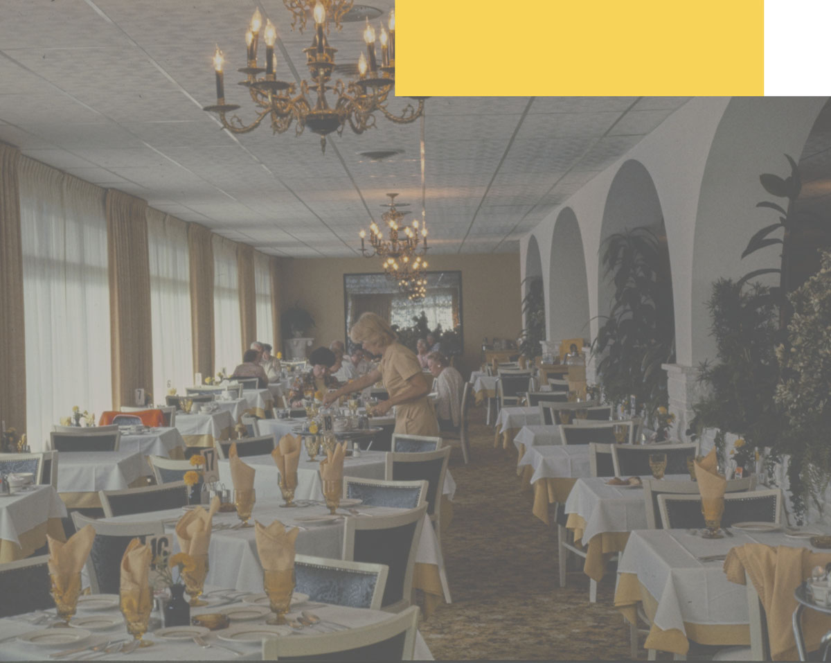 A luxurious dining room with many round tables and a large window.