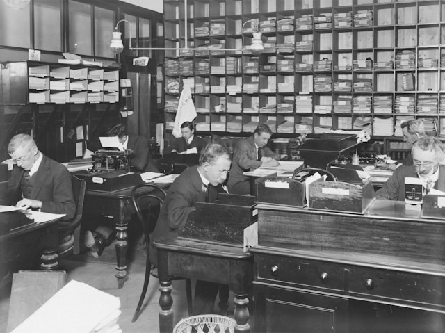 an old photo of an office with people working